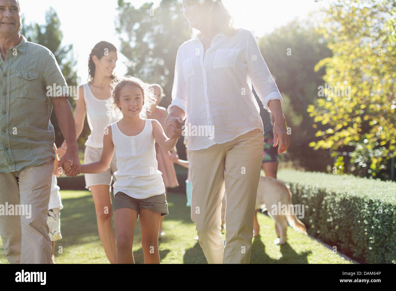 Family walking together in backyard Stock Photo