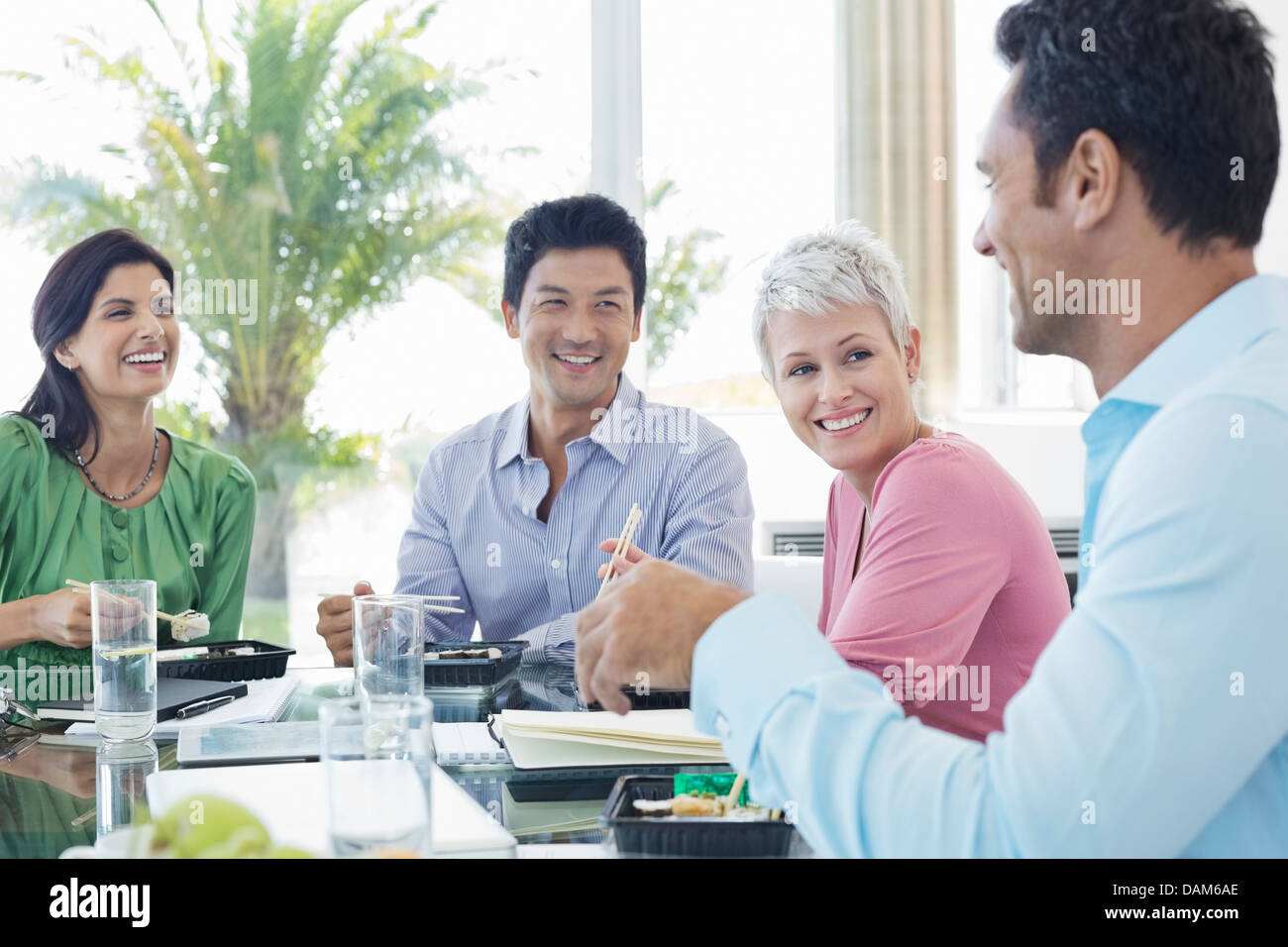 Business people smiling in lunch meeting Stock Photo