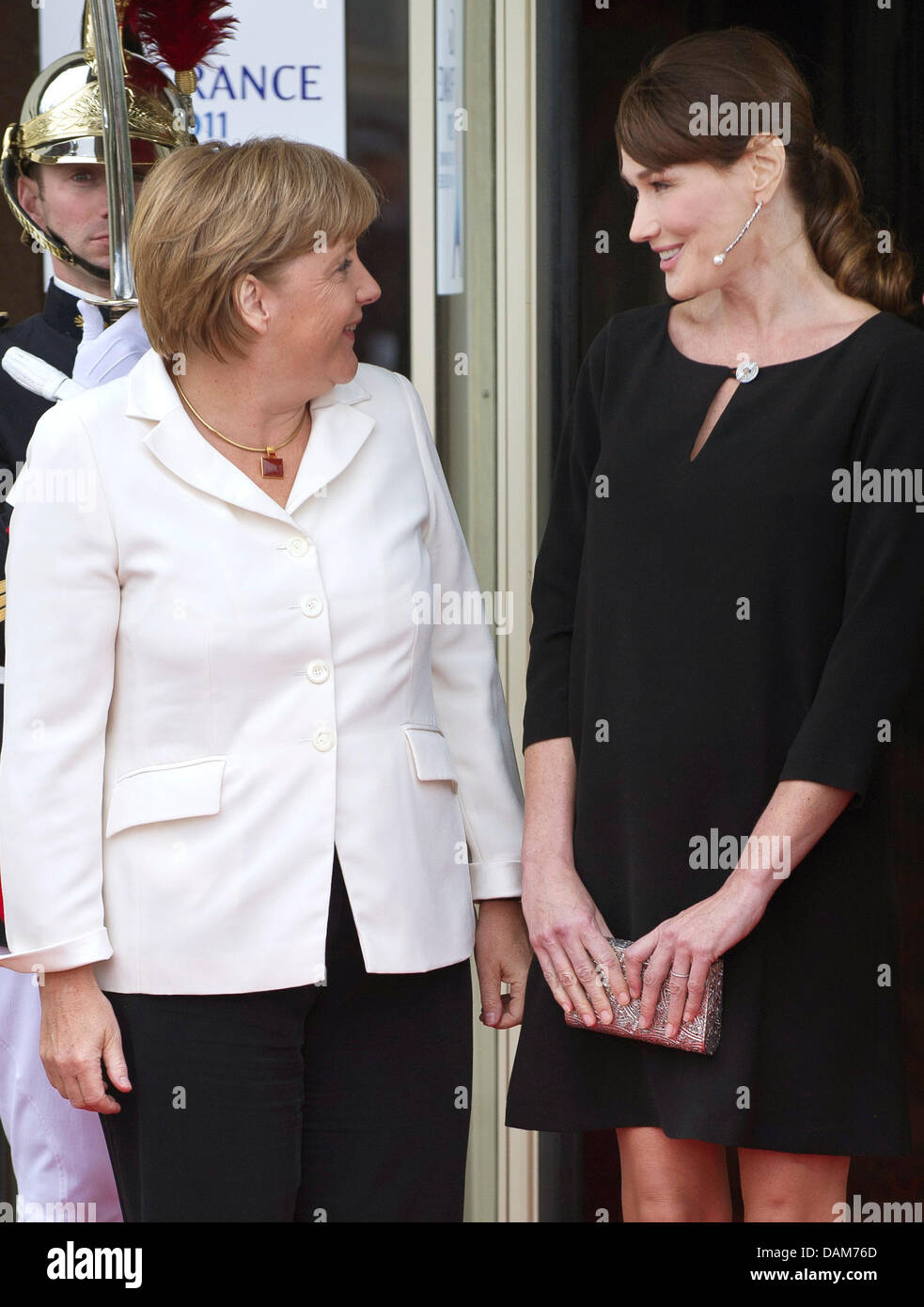 The wife of French President Nicolas Sarkozy, Carla Bruni-Sarkozy (r) greets German Chancellor Angela Merkel for the G8 summit meeting in the seaside resort of Deauville, France, 26 May 2011. The G8 summit meeting takes place in Deauville on 26 and 27 May 2011. Photo: Peer Grimm Stock Photo