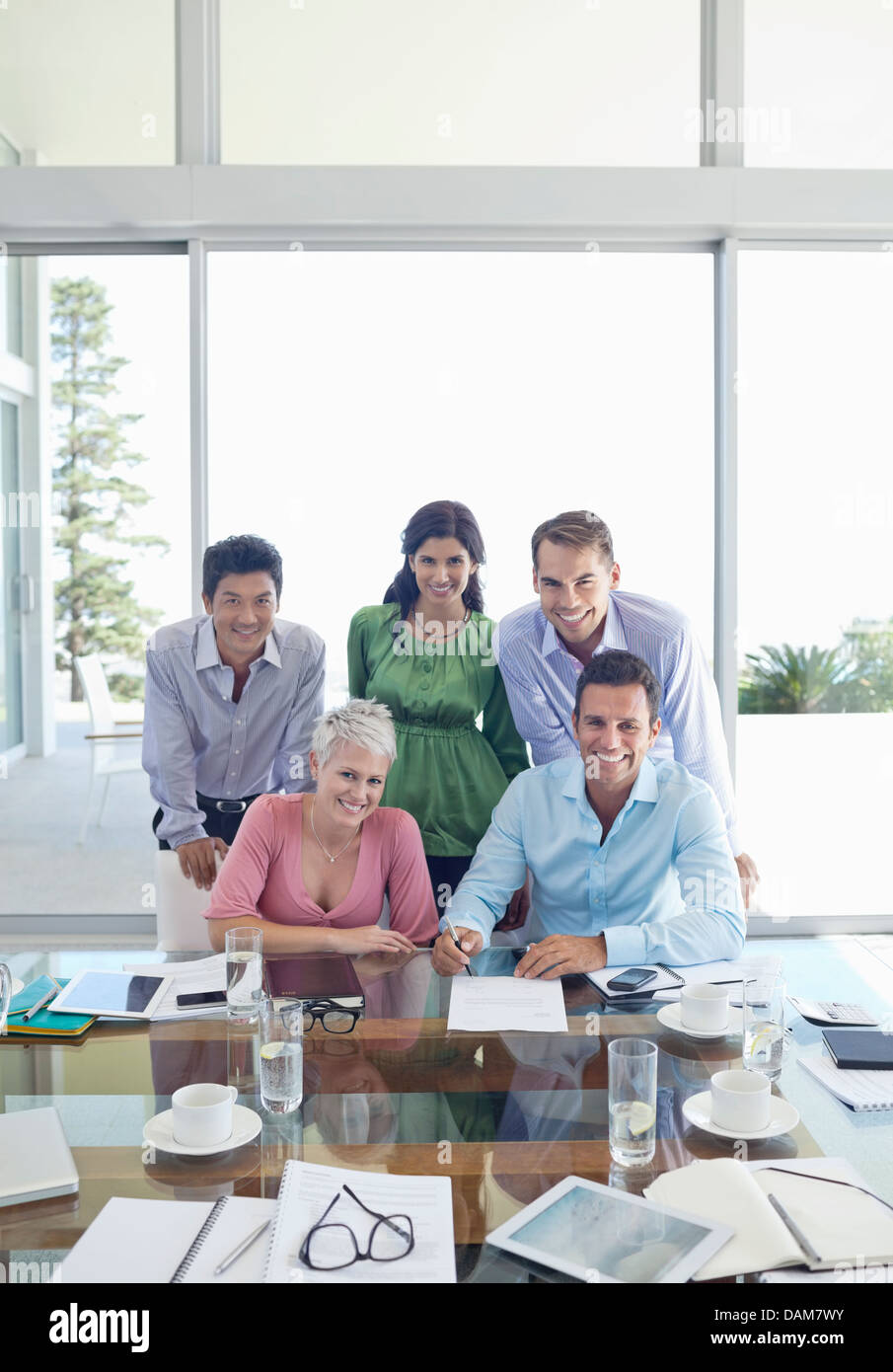 Business people smiling in meeting Stock Photo Alamy
