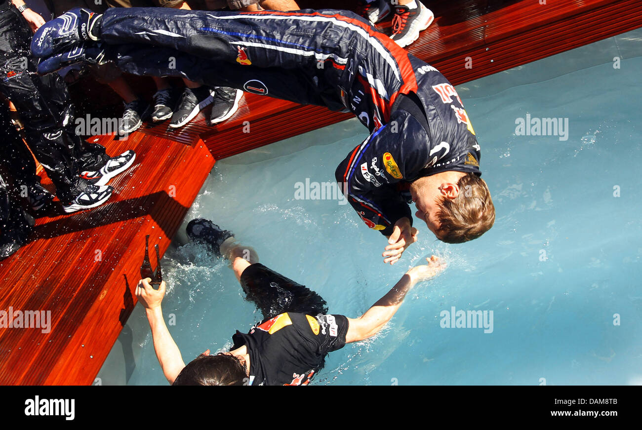German Formula One driver Sebastian Vettel of Red Bull Racing celebrates  his victory in the swimming pool after winning the Formula 1 Grand Prix of  Monaco at the street circuit of Monte