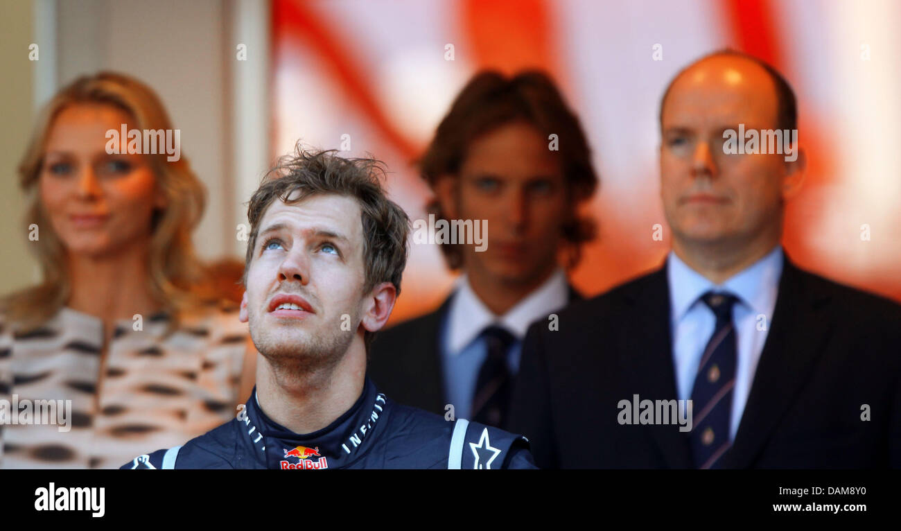 German Formula One Driver Sebastian Vettel C Of Red Bull Prince Albert Of Monaco R And His Girlfriend Charlene Wittstock On The Podium After The Grand Prix Of Monaco At The F1