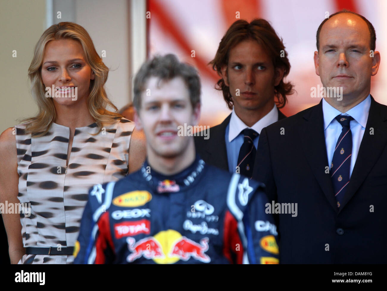 German Formula One Driver Sebastian Vettel C Of Red Bull Prince Albert Of Monaco R And His Girlfriend Charlene Wittstock On The Podium After The Grand Prix Of Monaco At The F1