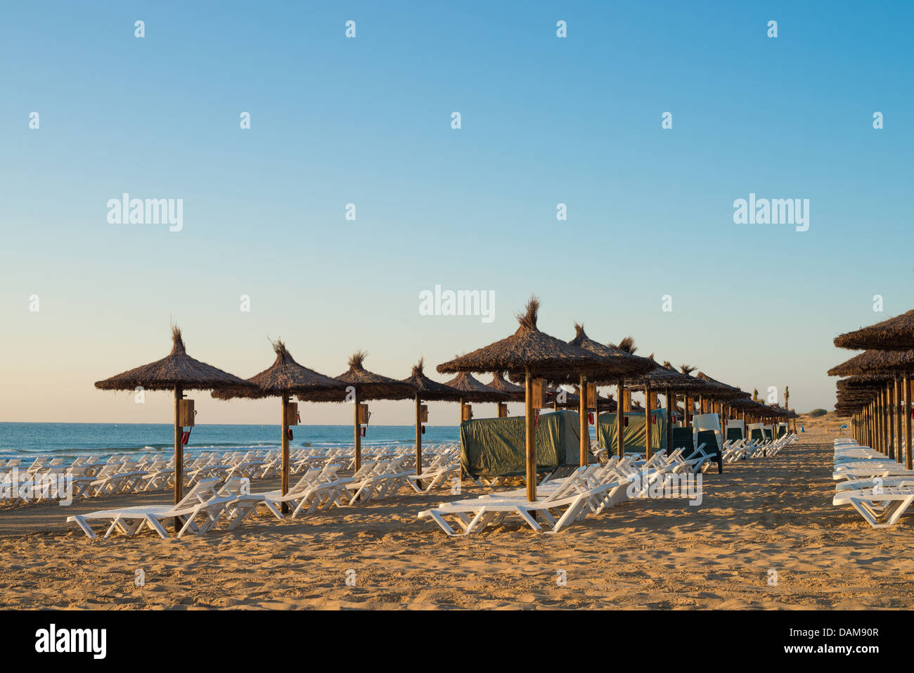 Sunshades early morning on Carabassi beach, Costa Blanca, Spain Stock Photo