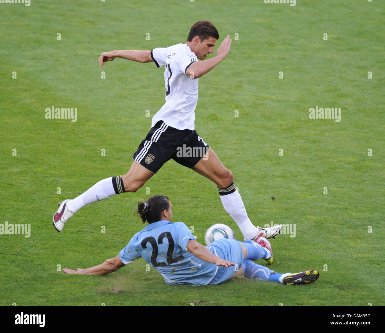 Germany's Mario Gomez (top) and Martin Caceres of Uruguay vie for the ball during soccer friendly Germany vs. Uruguay at Rhein-Neckar-Arena in Sinsheim, Germany, 29 May 2011. Germany won the friendly match 2-1. Photo: Uli Deck Stock Photo