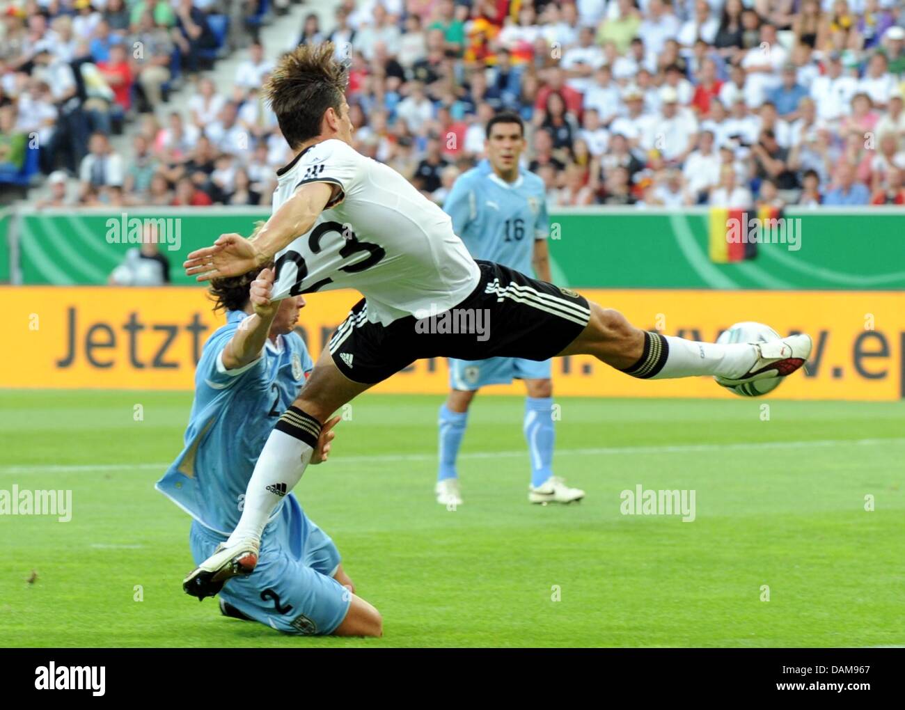 Germany's Mario Gomez (r) and Diego Lugano (l) of Uruguay vie for the ball during the soccer friendly Germany vs. Uruguay at Rhein-Neckar-Arena in Sinsheim, Germany, 29 May 2011. Germany won the friendly match 2-1. Photo: Bernd Weissbrod Stock Photo