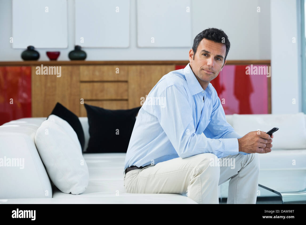 Businessman sitting on sofa Stock Photo