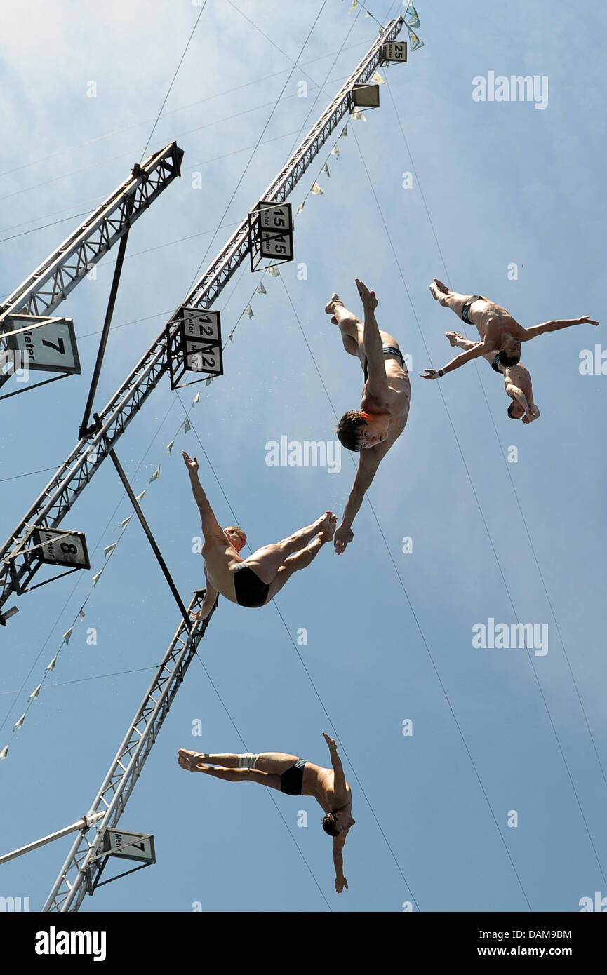Five highdivers jump from their podium into the water during the