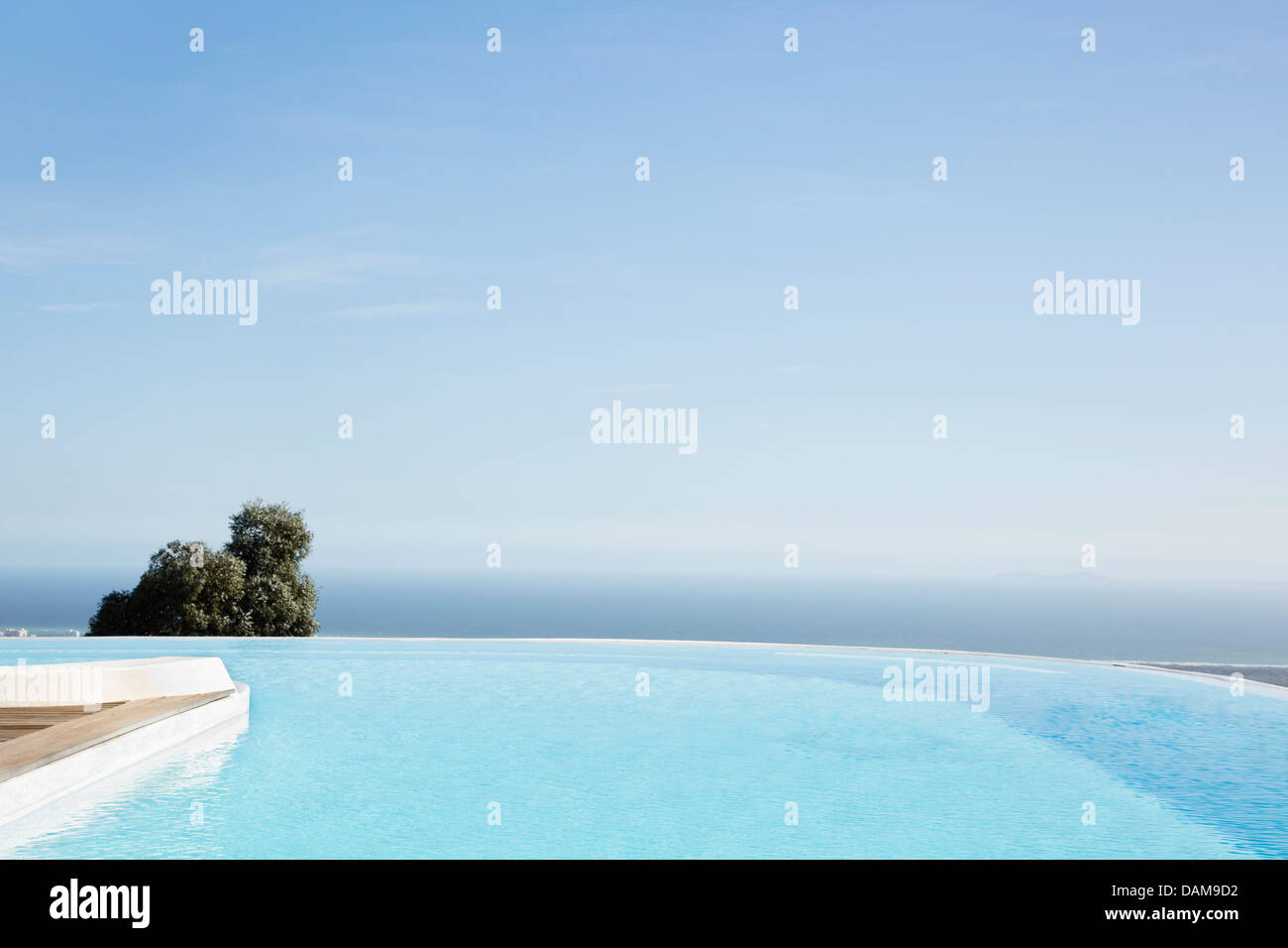 Infinity pool overlooking hillside Stock Photo