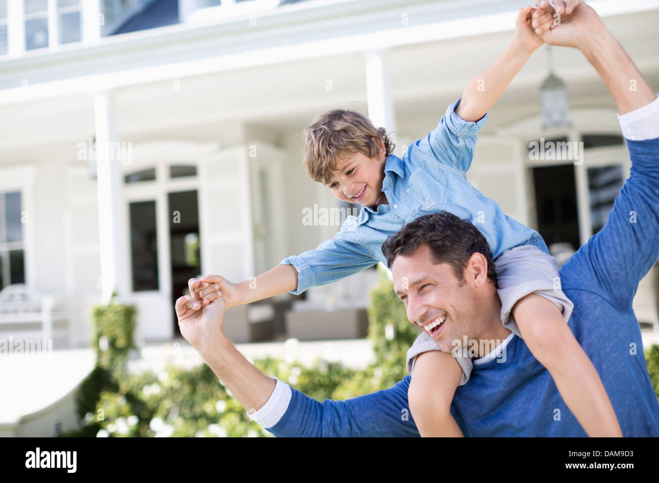Father and son playing outside house Stock Photo