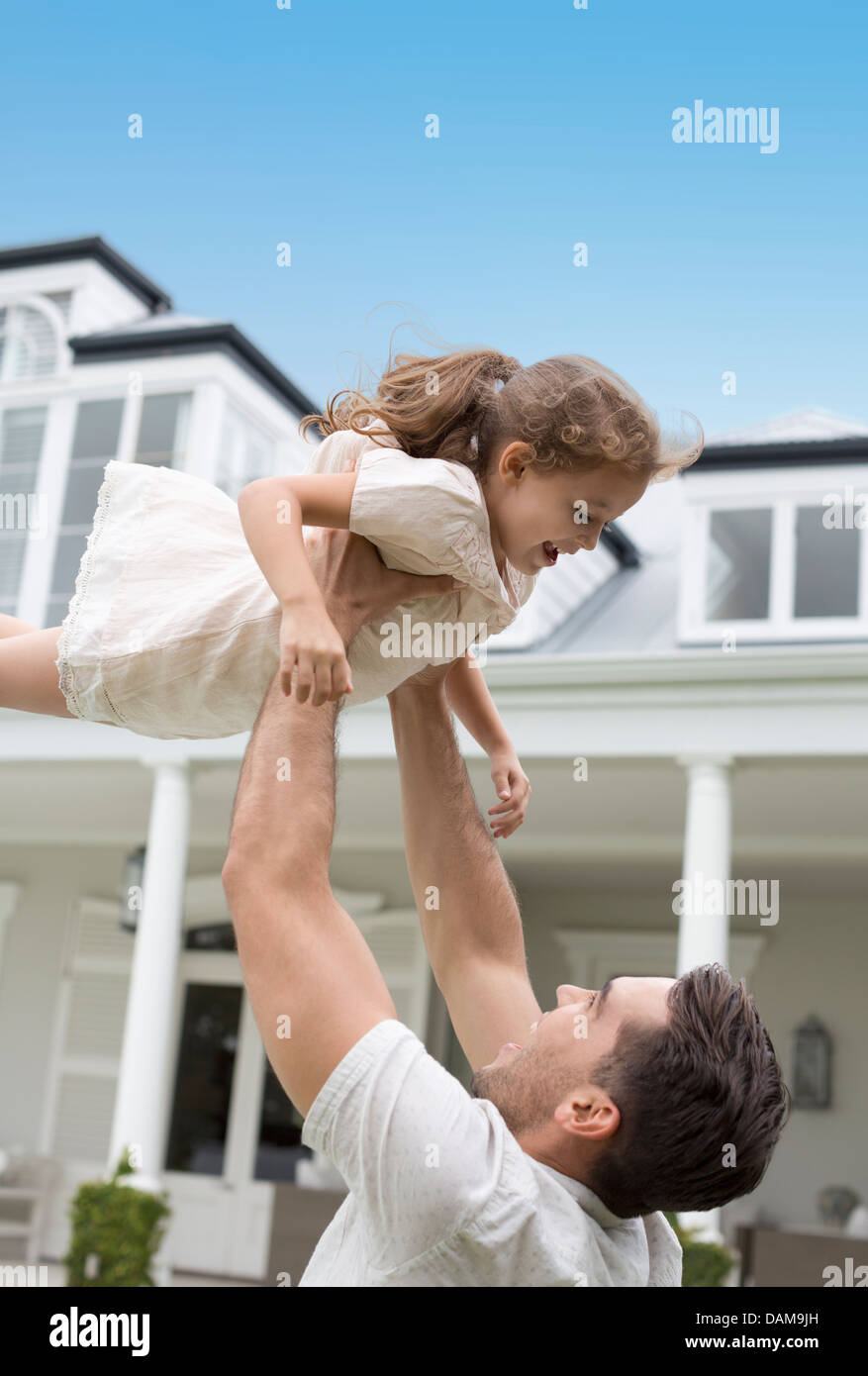 Father and daughter playing outdoors Stock Photo