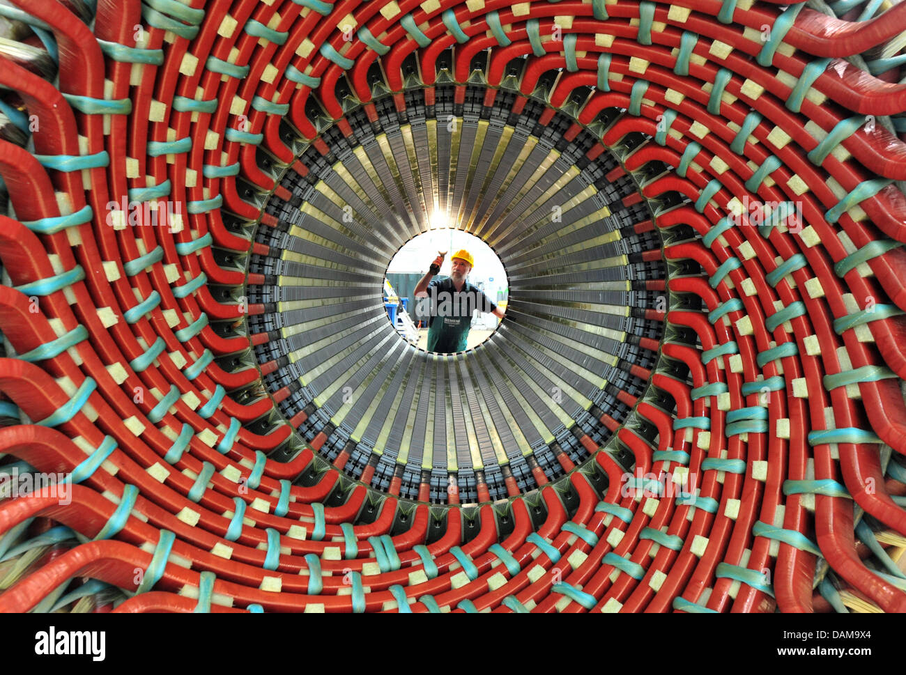 A Siemens employee inspects a generator stator at the Siemens Power  Generation in Erfurt, Germany, 31 May 2011. The power generation by Siemens  Energy is a world-wide competence center for air-cooled generators