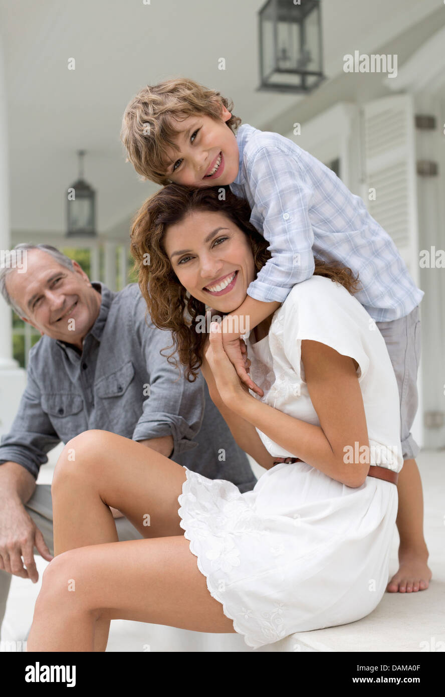 Mother and son smiling on porch Stock Photo