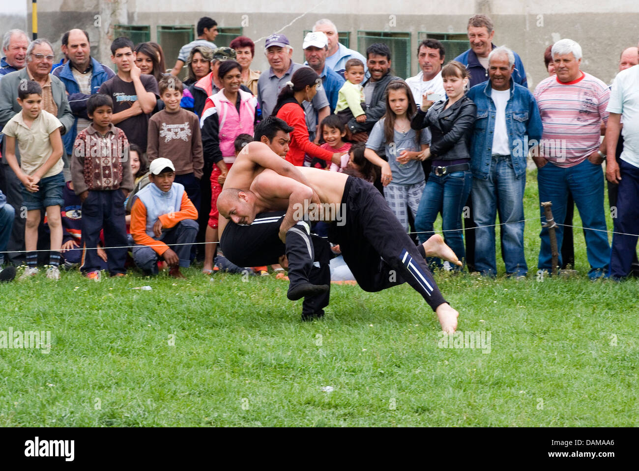 Bulgarian's wrestling during village day celebrations in a Mountian Strandja village of Malomirovo watched by family, visitors a Stock Photo