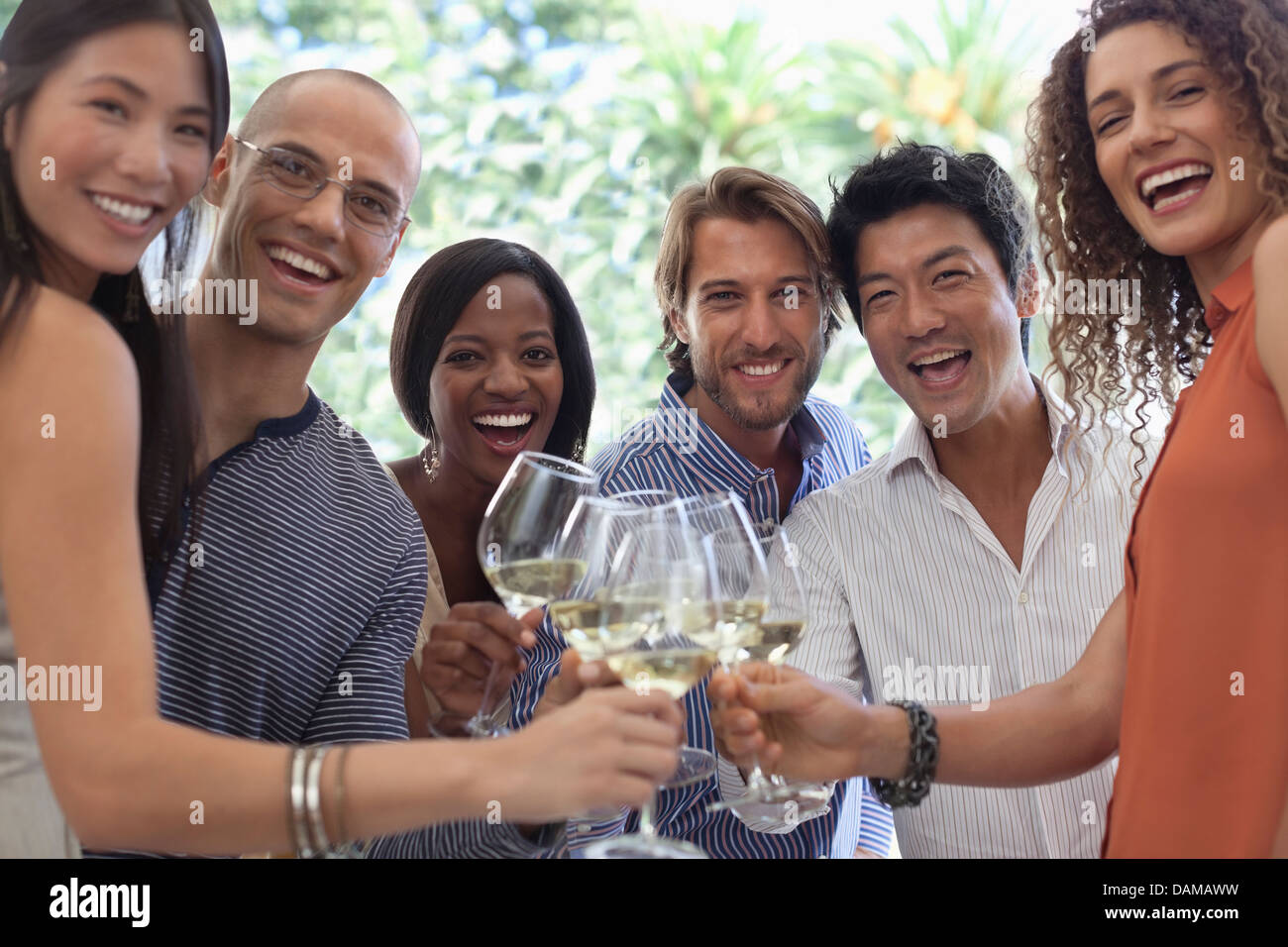 Friends toasting each other at party Stock Photo