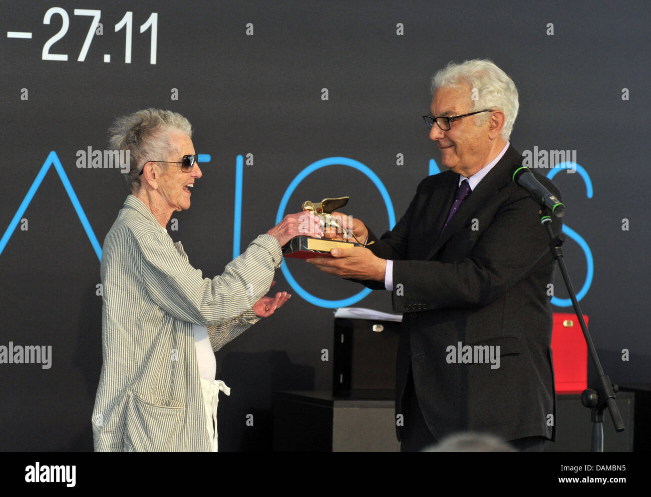 The president of the Venice Biennale, Paolo Baratta (R), hands over a Golden Lion for lifetime achievement to artist Elaine Sturtevant (L) during the opening of the 54th Venice Biennale in Venice, Italy, 04 June 2011. The Biennale takes place every two years in Venice, Italy. Photo: Felix Hoerhager Stock Photo
