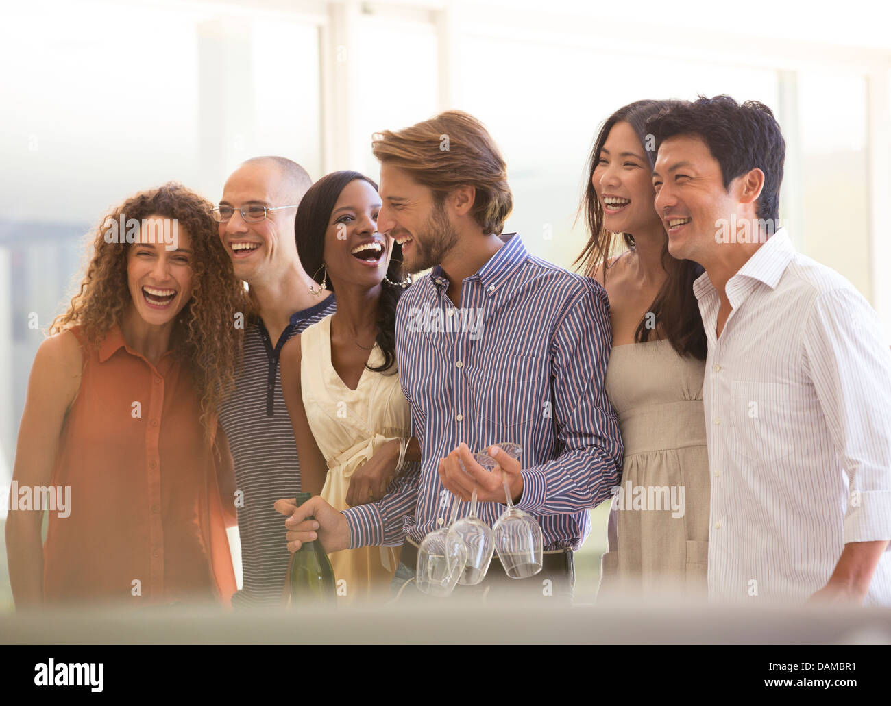 Friends Laughing Together At Party Stock Photo Alamy