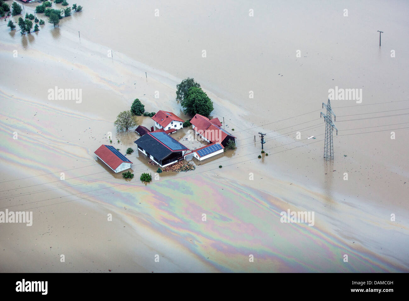 flooded farmhouse by river Inn with oil film during flood in June 2013, Germany, Bavaria, Schaerding Stock Photo