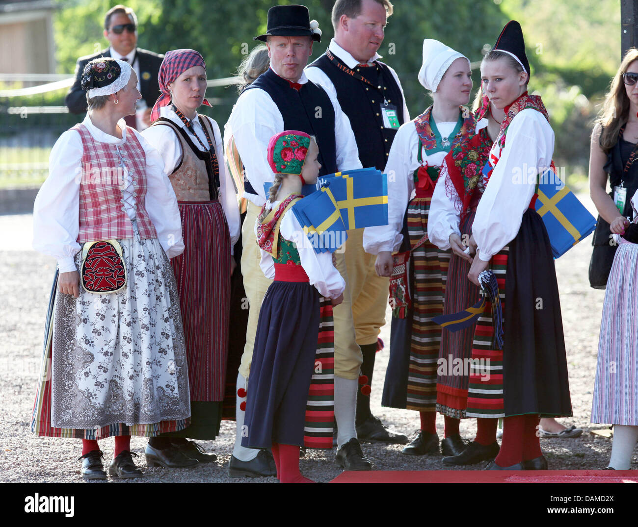Swedish citizens in national costumes wait for the arrival of the royal