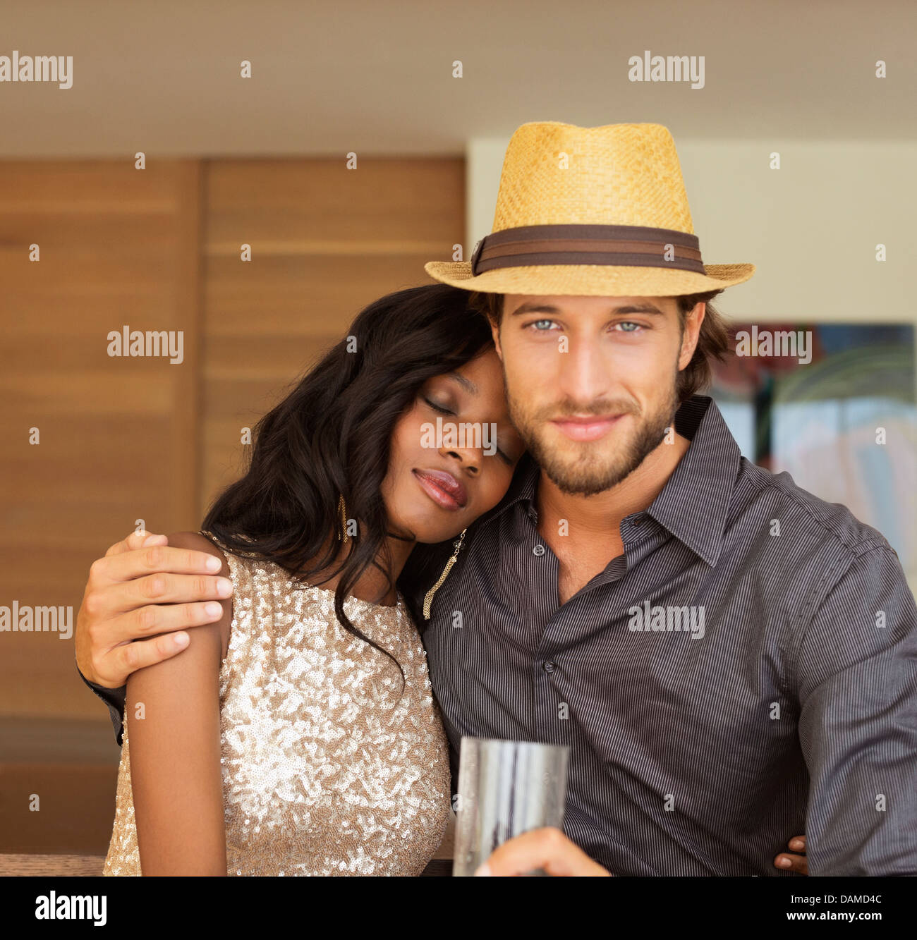 Couple hugging indoors Stock Photo