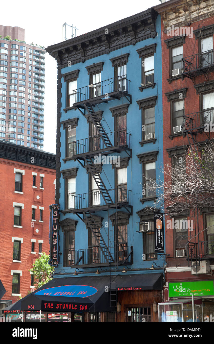 Colorful apartment buildings with fire escapes in New York City Stock Photo
