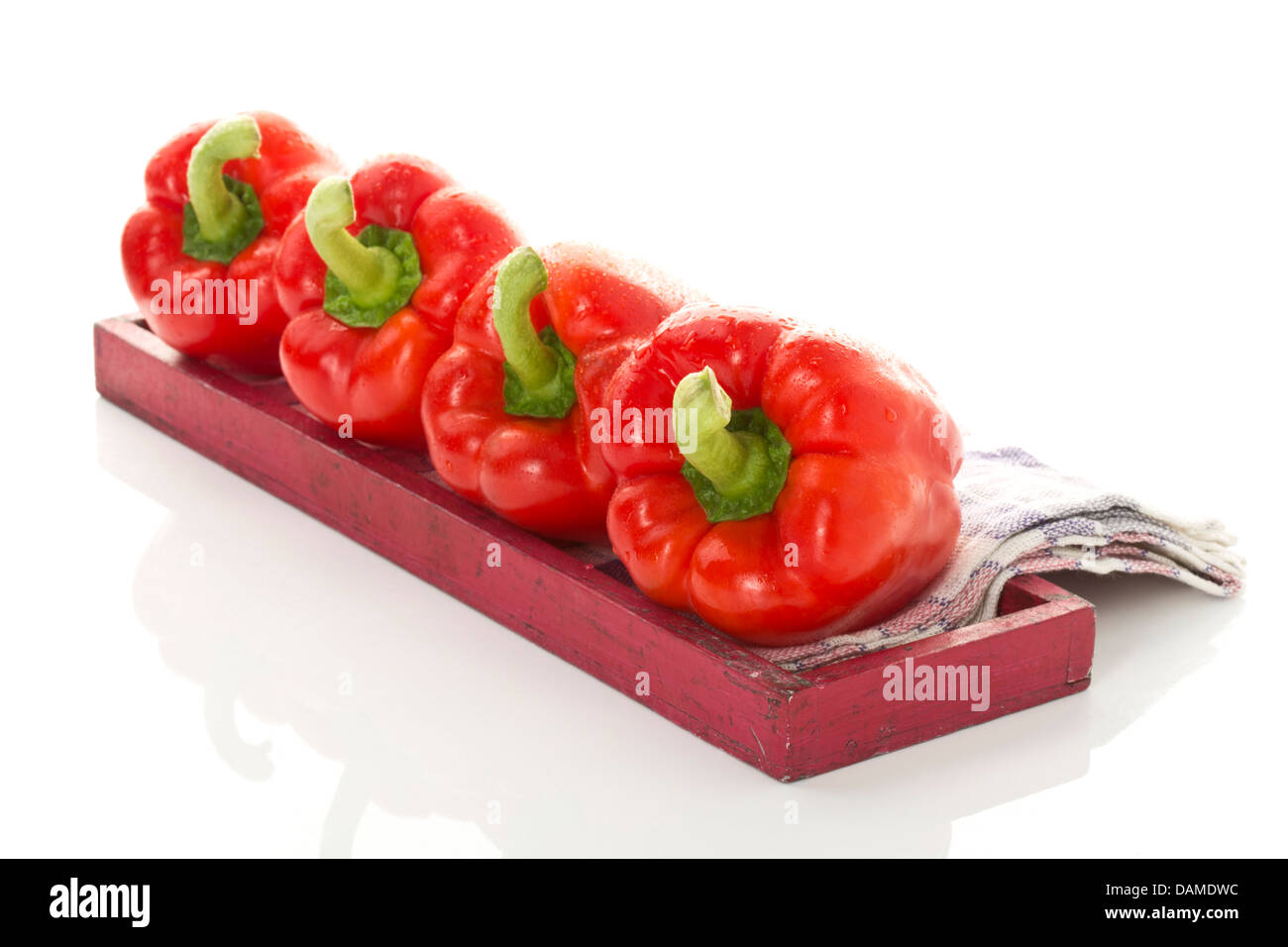 Red bell peppers on wooden tray, close up Stock Photo - Alamy