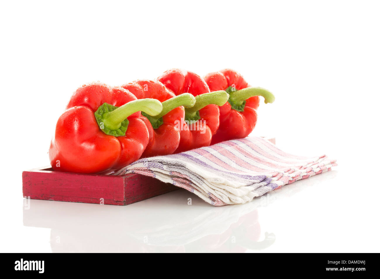 Red bell peppers on wooden tray, close up Stock Photo - Alamy
