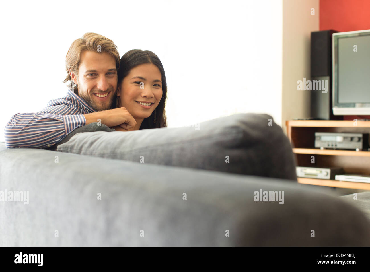 Couple relaxing together on sofa Stock Photo