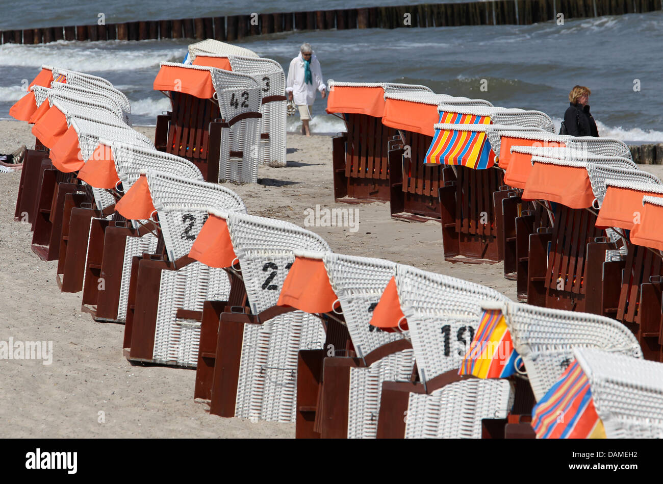 Beach chairs are situated at a beach at the Baltic Sea for visitors in Kuehlungsborn, Germany, 09 June 2011. Although the sun is shining, temperatures around 18 degrees Celsius and wind keep visitors away. Photo: Bernd Wuestneck Stock Photo