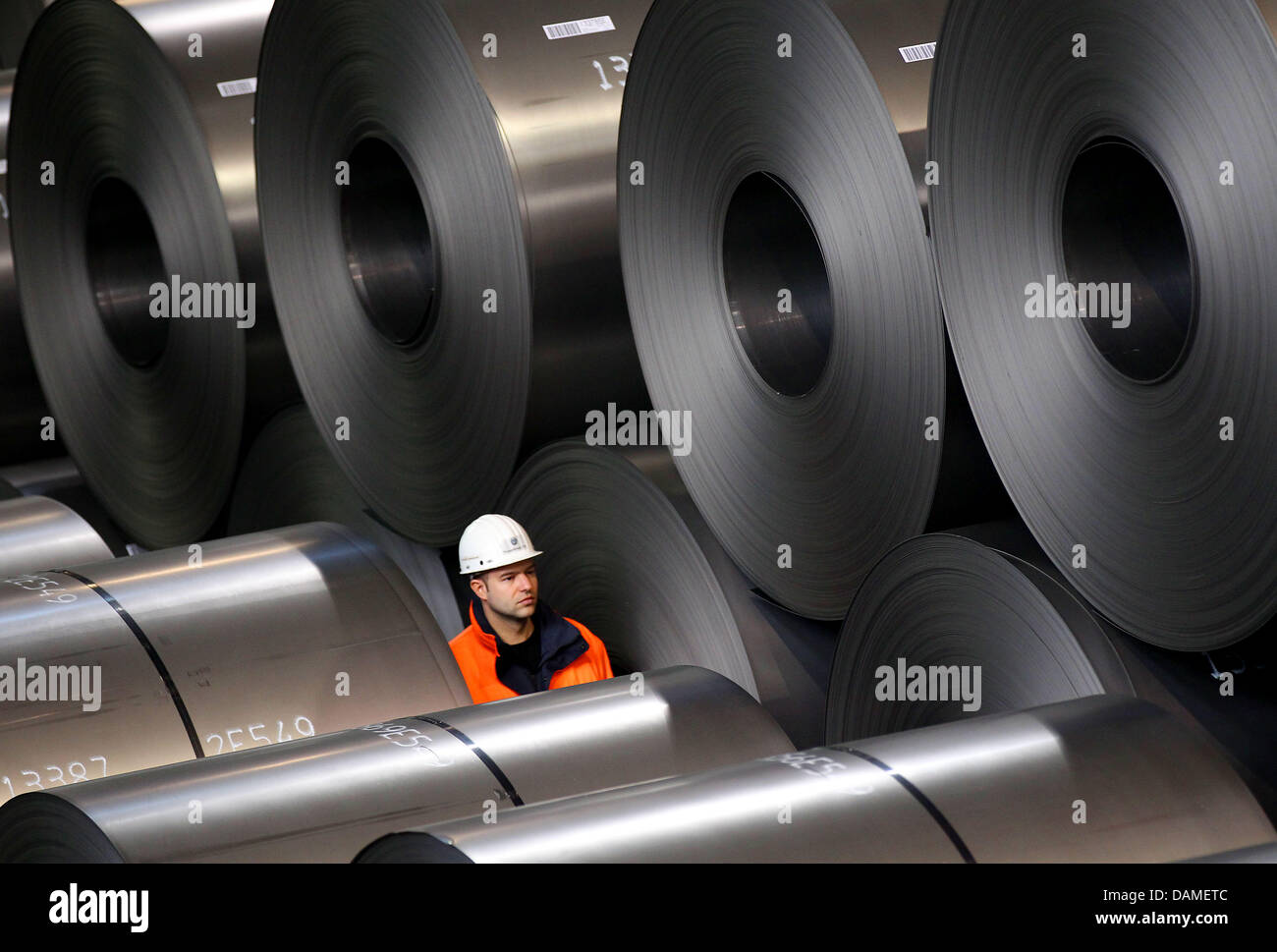 (FILE) An archive photo dated 09 February 2011 shows an employee of Thyssenkrupp inspecting coils of raw steel at the steel factory in Duisburg, Germany. Business at ThyssenKrupp is getting better and steel production in Germany is rising again. In total, 4.1 million tons of steel was produced, one percent more than a year ago, according to the trade association Stahl (steel) in Du Stock Photo