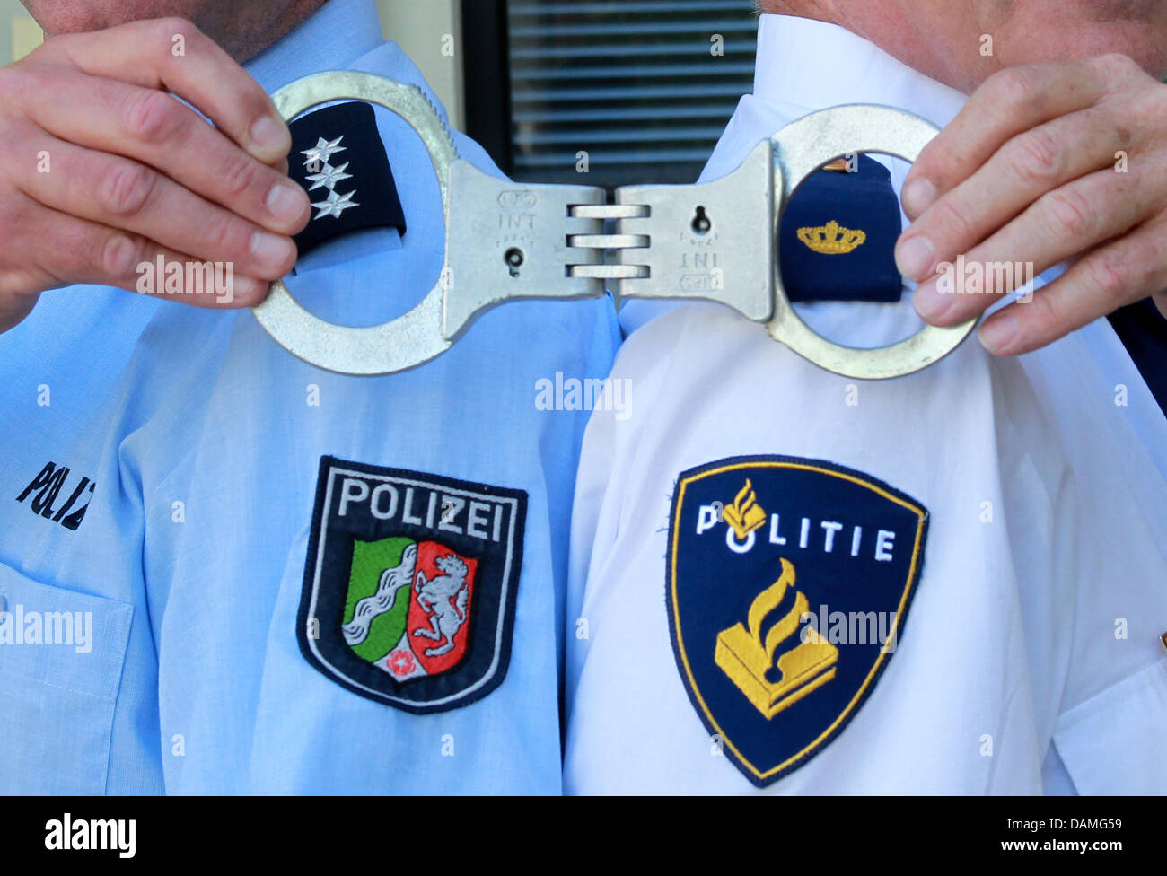 German And Dutch Police Pose Witch Handcuffs In Moenchengladbach Germany 25 May 2011 District