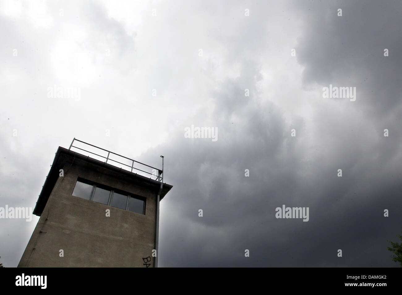 Dark clouds move over the watchtower Schlesischer Busch at the start of ...