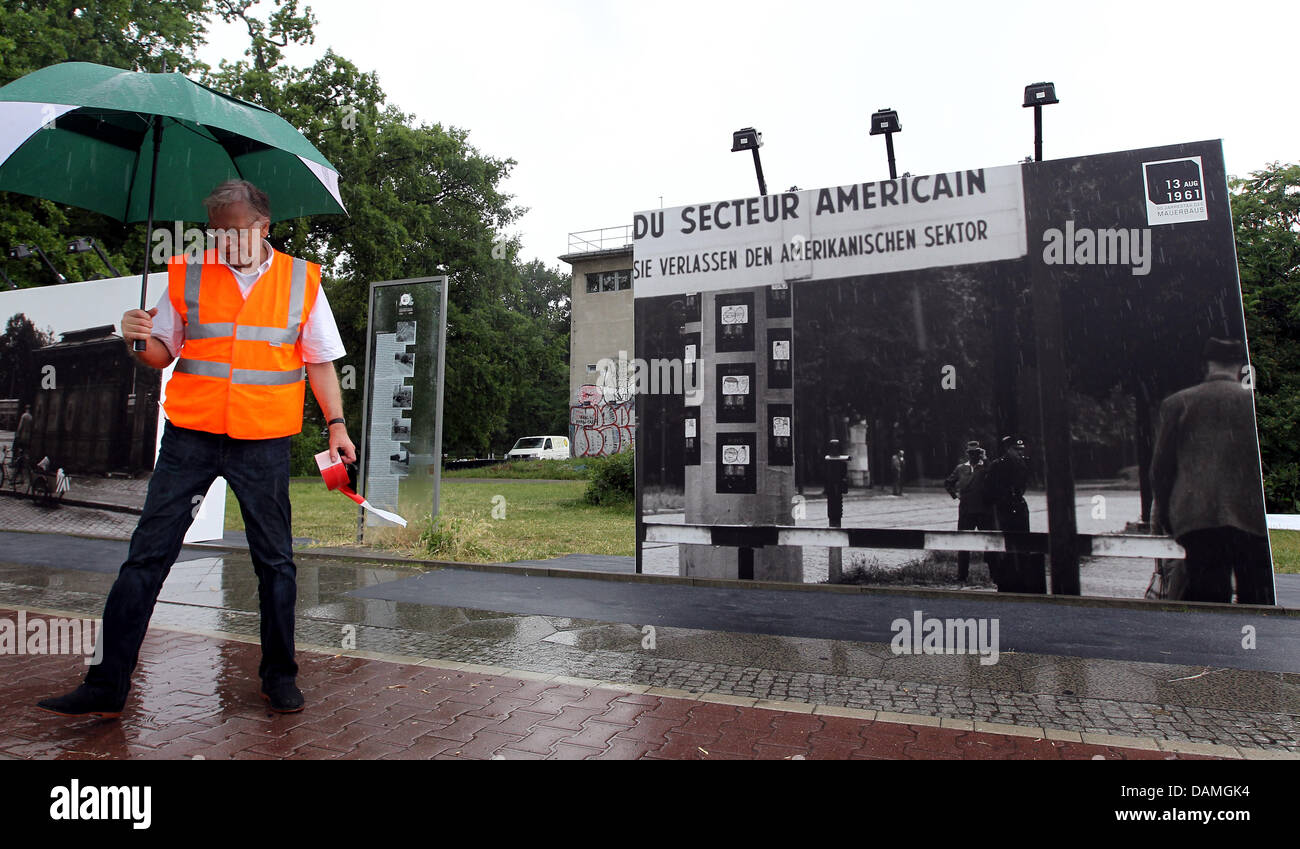 A guard secures a picture of the Wall at the area of the watchtower