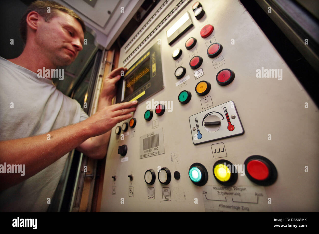 Technician Sven Beschorner works on an air condition inside a Deutsche Bahn InterCity (IC) train at the ICE plant in Leipzig, Germany, 14 June 2011. Among other technical equipment, the thermostats are regularly checked. Especially those inside ICE trains were often overloaded last summer. Photo: Jan Woitas Stock Photo