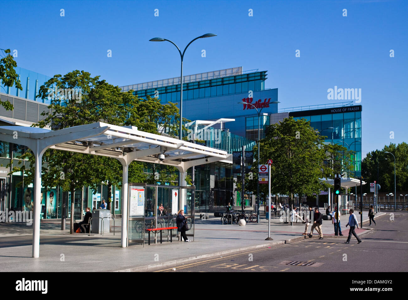 Bus stops outside Shepherds Bush station with Westfield shopping centre behind, London Stock Photo