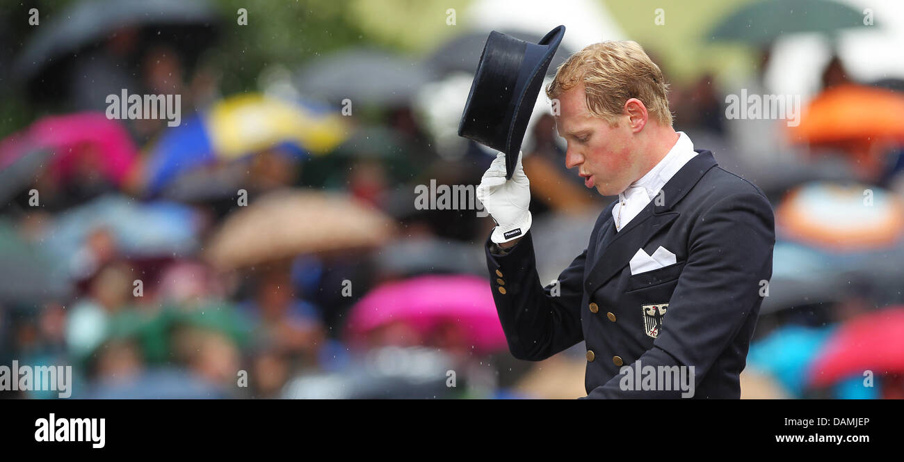 Rider Matthias Rath takes off his hat after his competition at the ...