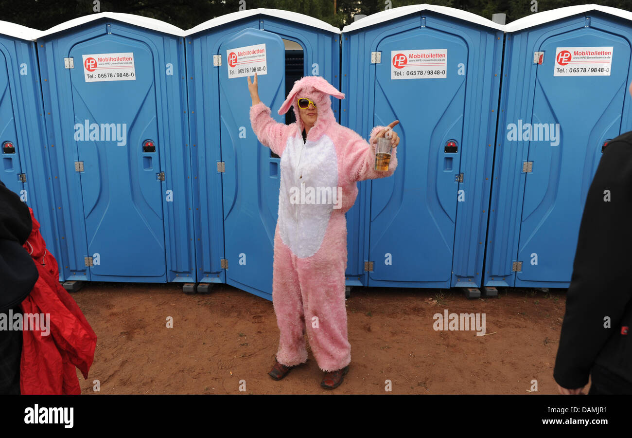 A woman wearing a pink rabbit costume stands in front of the toilets at the Hurrican Festival in Scheessel, Germany, 18 June 2011. About 80 band are going to perform during the three-day festival which will be visited by 73 000 fans. Photo: Julian Stratenschulte Stock Photo