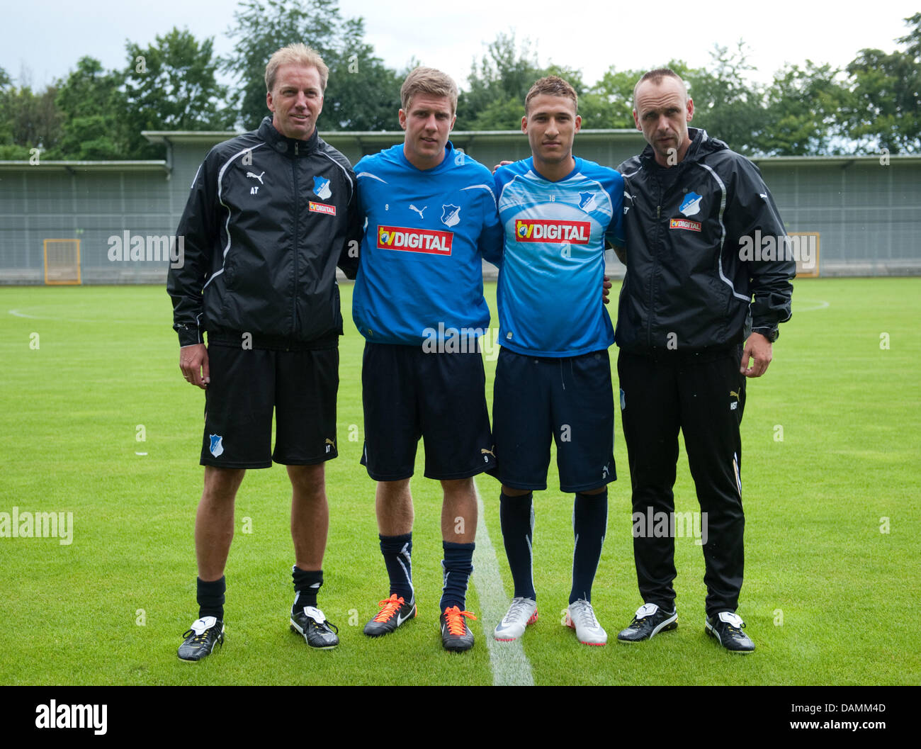 The newly transferred players (l-r) co-coach Andre Trulsen, Sven Schipplock, Fabian Johnson and Hoffenheim's coach Holger Stanislawski stand on the pitch at Dietmar-Hopp stadium for the beginning of the new training session of TSG 1899 Hoffenheim in Hoffenheim, Germany, 22 June 2011. Photo: Uwe Anspach Stock Photo