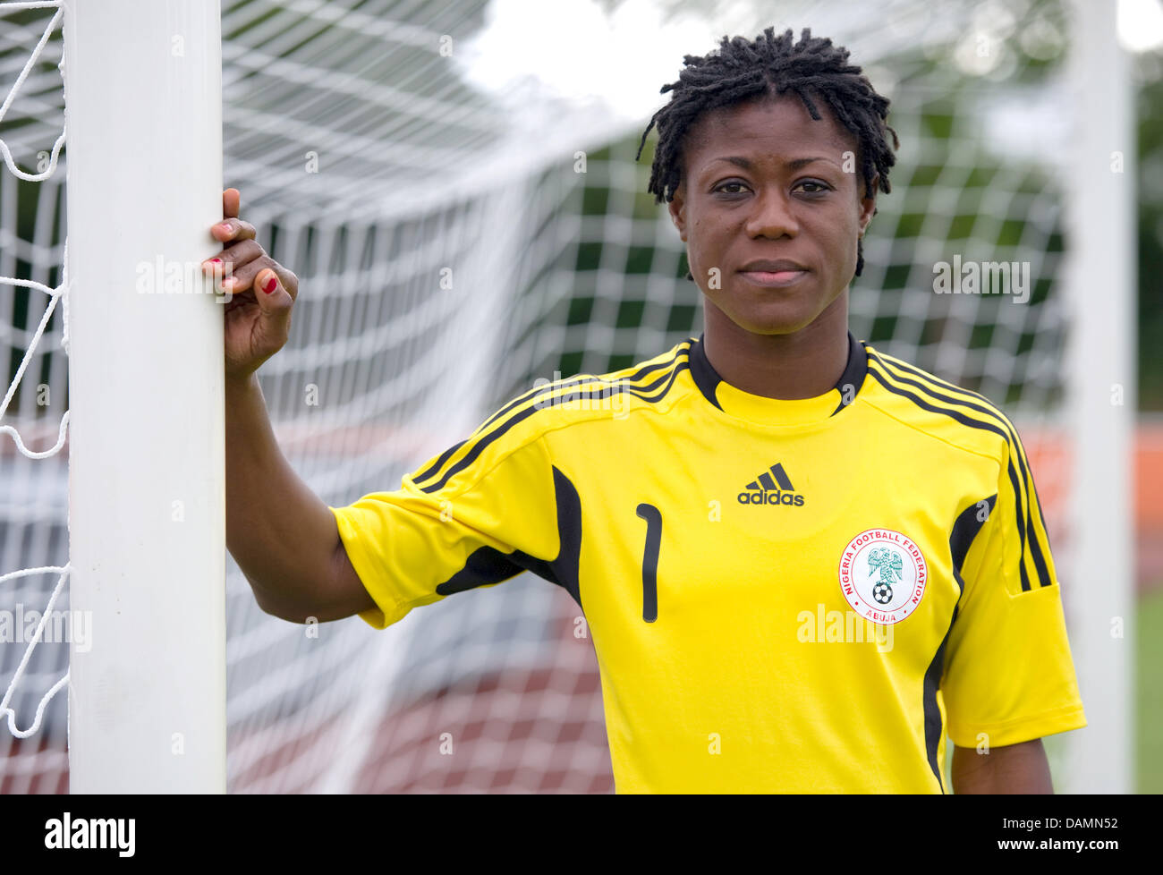 The goalkeeper of the Nigerian national women's soccer team, Precious Dede, stands at a goalpost during practice in Heidelberg, Germany, 23 June 2011. The Nigerian team plays its first match against France on 26 June 2011. Photo: Uwe Anspach Stock Photo