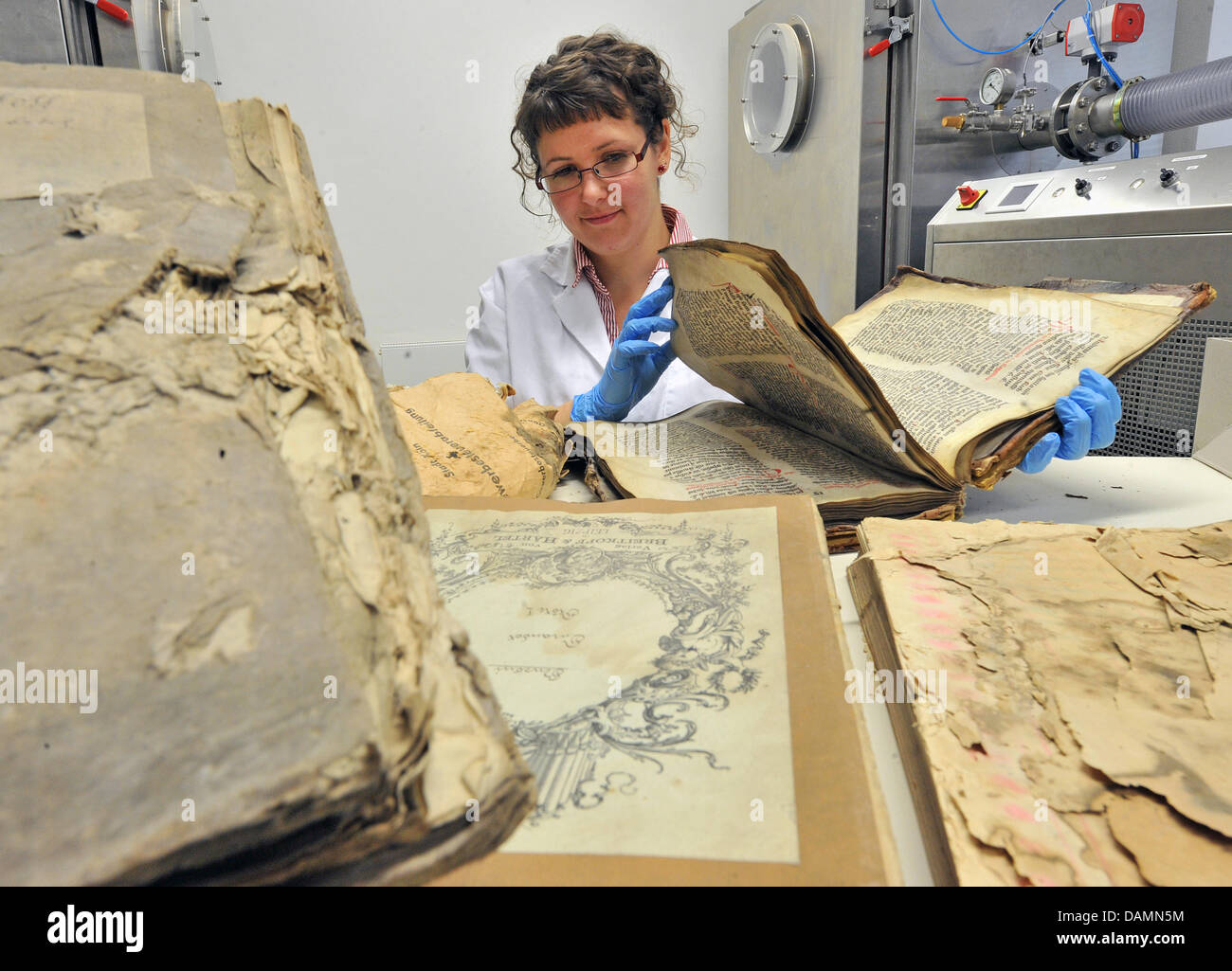 Restorer Wiebke Findeisen examines damaged historical books from the ...