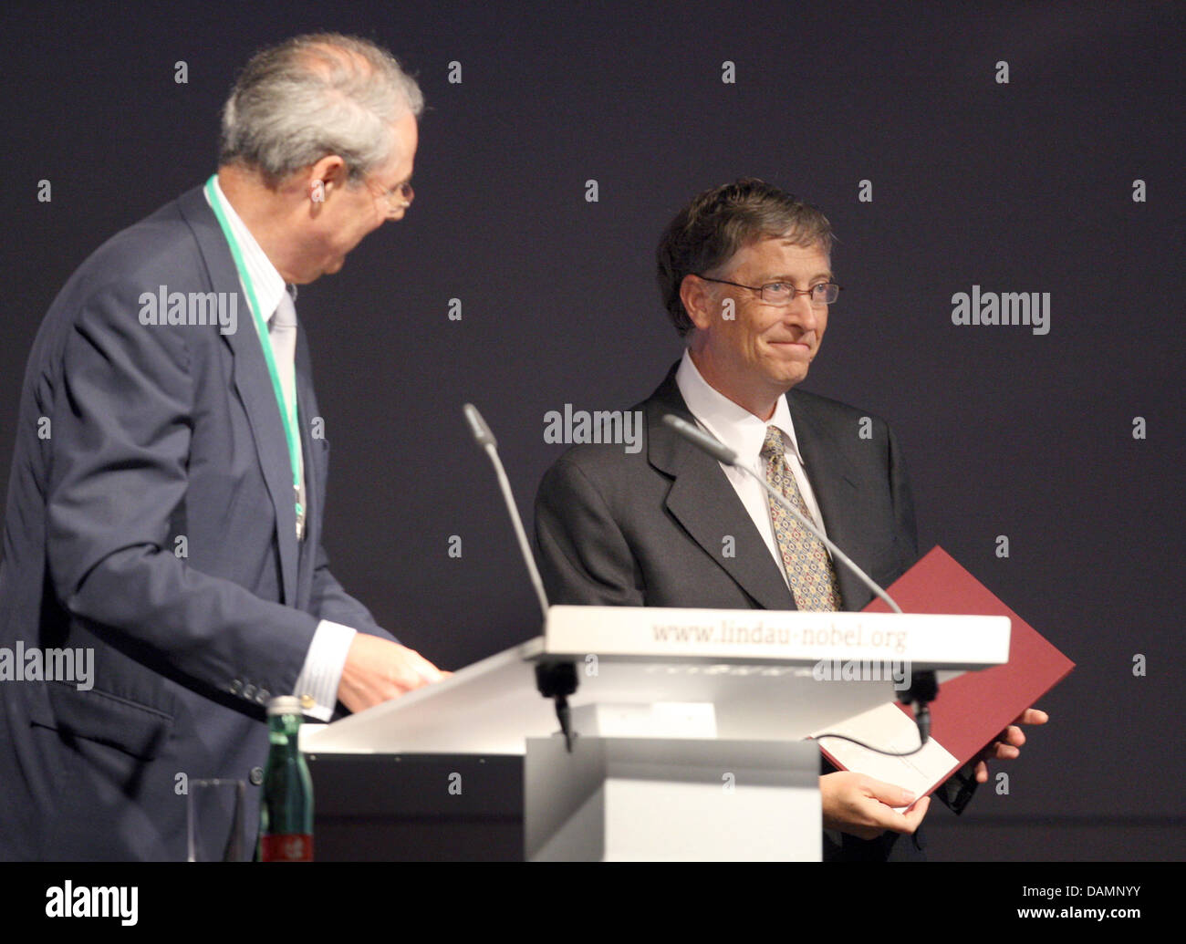 Microsoft founder Bill Gates (R) reiceived the letter of appointment to the honorary senate of the Nobel Laureate Meetings Foundation from the foundation's director Wolfgang Schuerer at the Nobel Laureate Meetings in Lindau, Germany, 26 June 2011. World health is in the limelight of the 61st meetings. Photo: Karl-Josef Hildenbrand Stock Photo