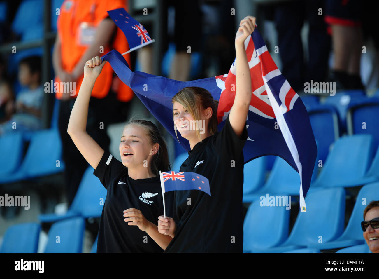 Fans with New Zealand flags cheer at a match between Japan and New