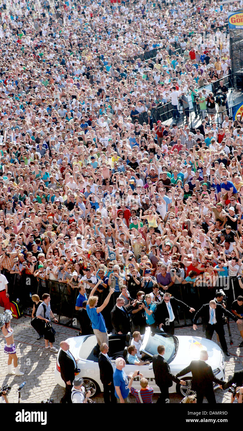 German basketball player Dirk Nowitzki (BOTTOM M) drives by the mass of fans in front of the Residence in Wuerzburg, Germany, 28 June 2011. About two weeks after winning the World Championship of the US American National Basketball Association (NBA), Germany's best basketball player visits his hometown Wuerzburg. Photo: FRANK RUMPENHORST Stock Photo