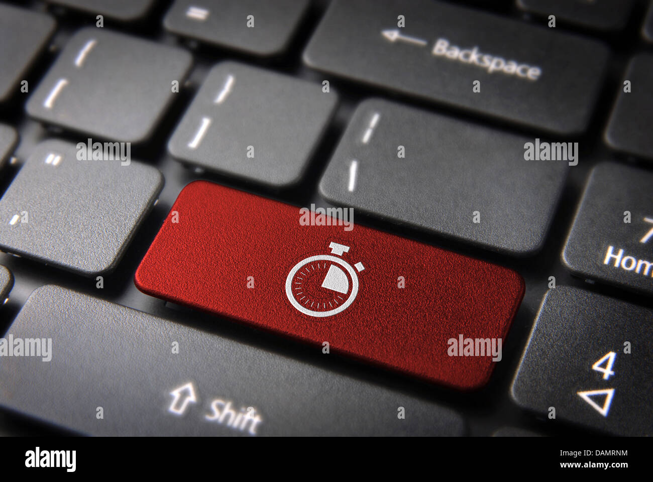 Time key with stopwatch icon on laptop keyboard. Included clipping path ...