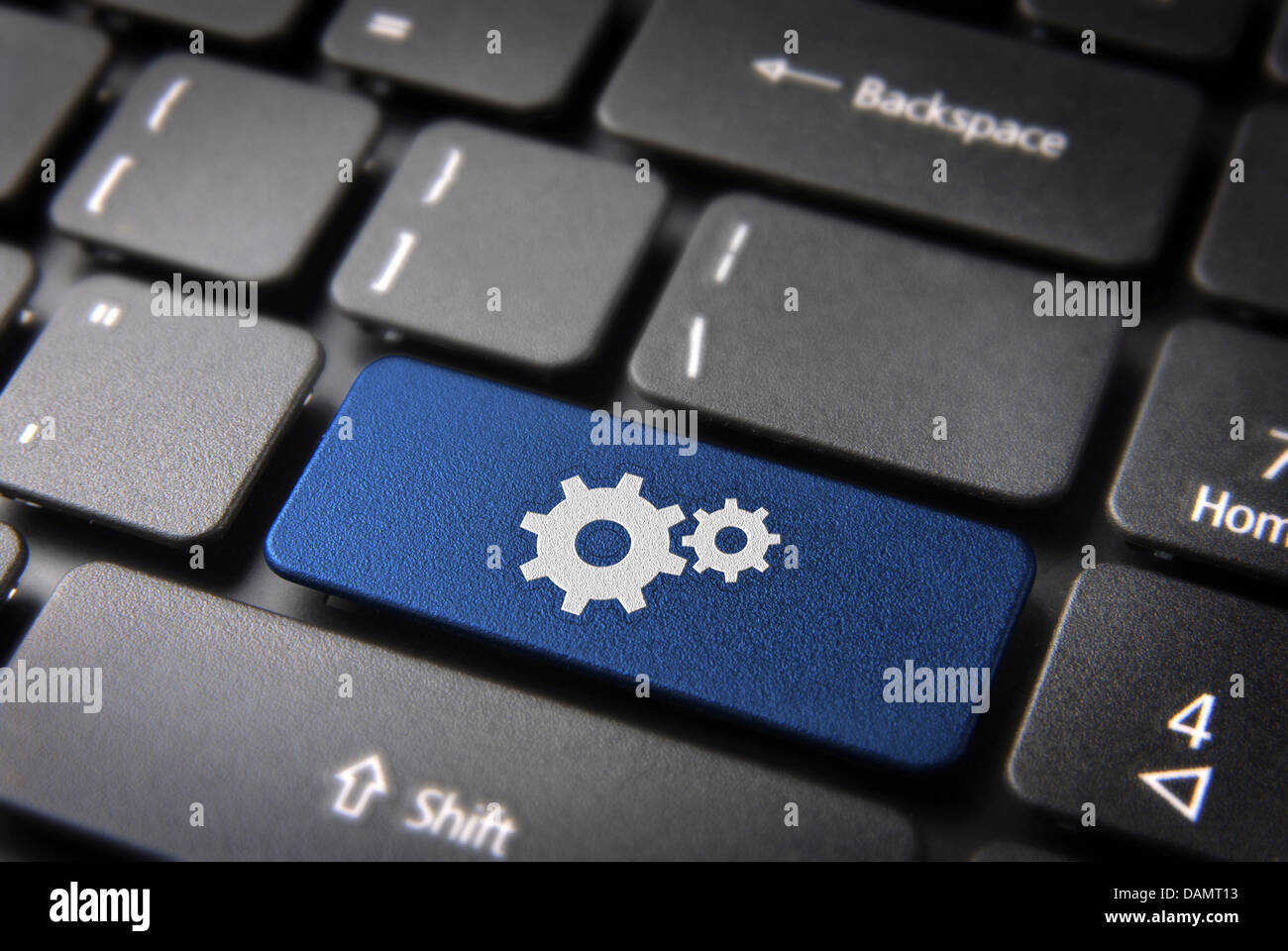 Industrial key with Gear wheel icon on laptop keyboard. Included clipping path, so you can easily edit it. Stock Photo