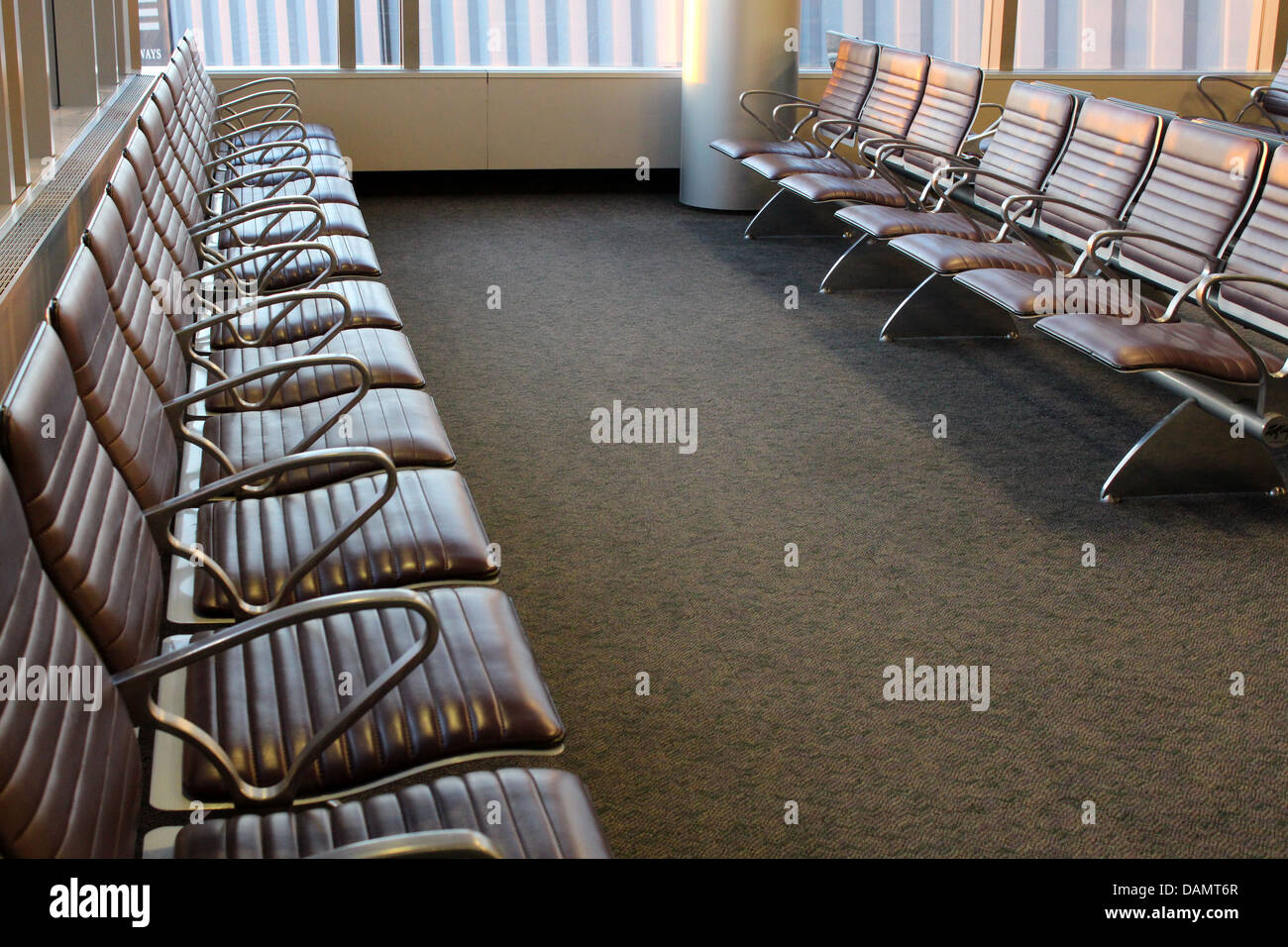 Empty rows of seats in comfortable airport lobby in early morning hours on any given day. Stock Photo