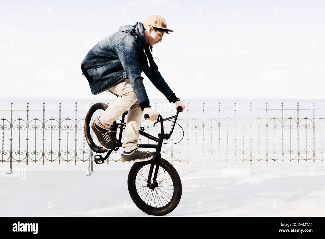 Germany, Schleswig Holstein, Teenage boy jumping with BMX bike Stock ...