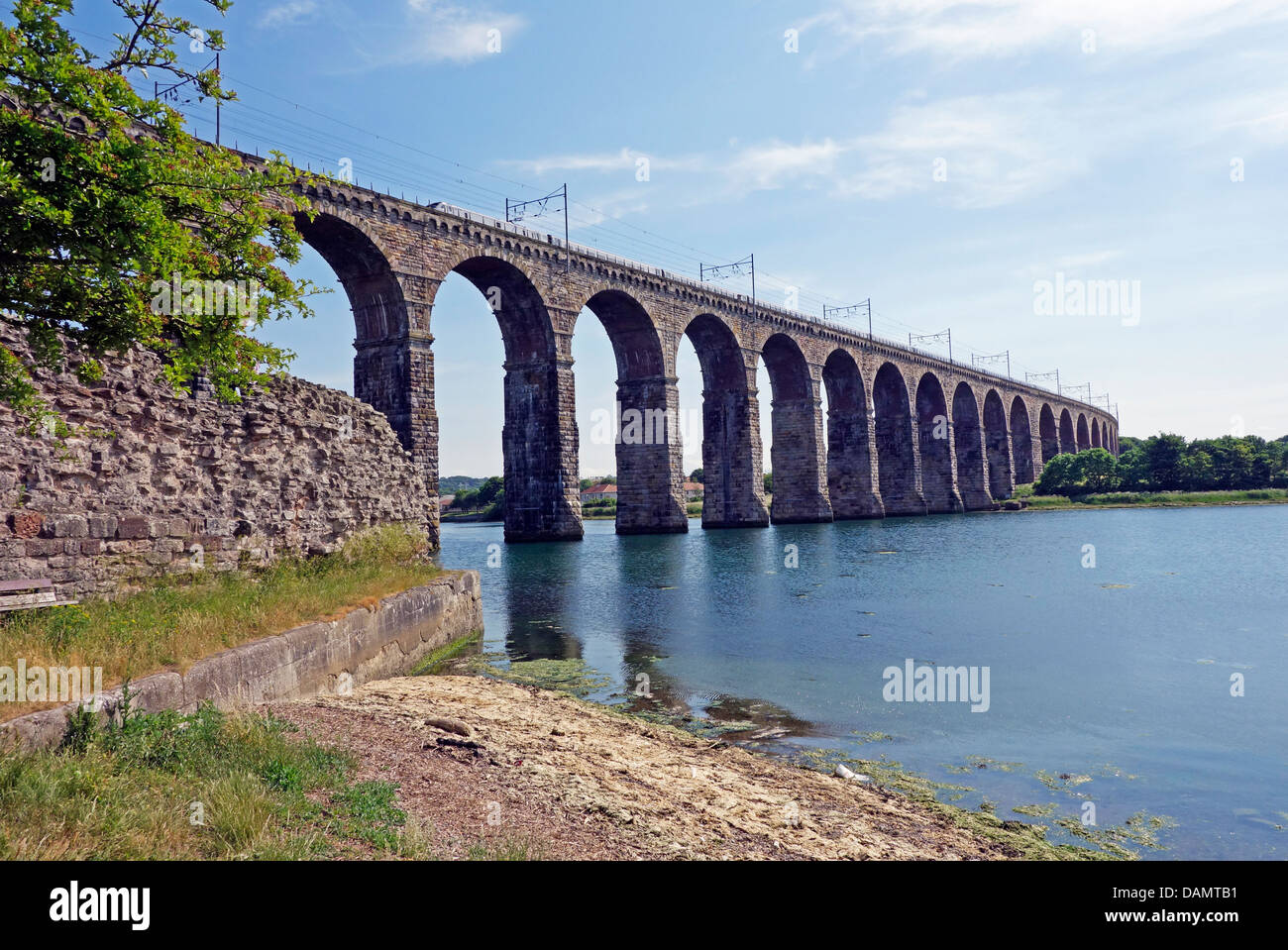 The Royal Border Bridge in Berwick -upon-Tweed England with southbound East Coast electric train passing over Stock Photo
