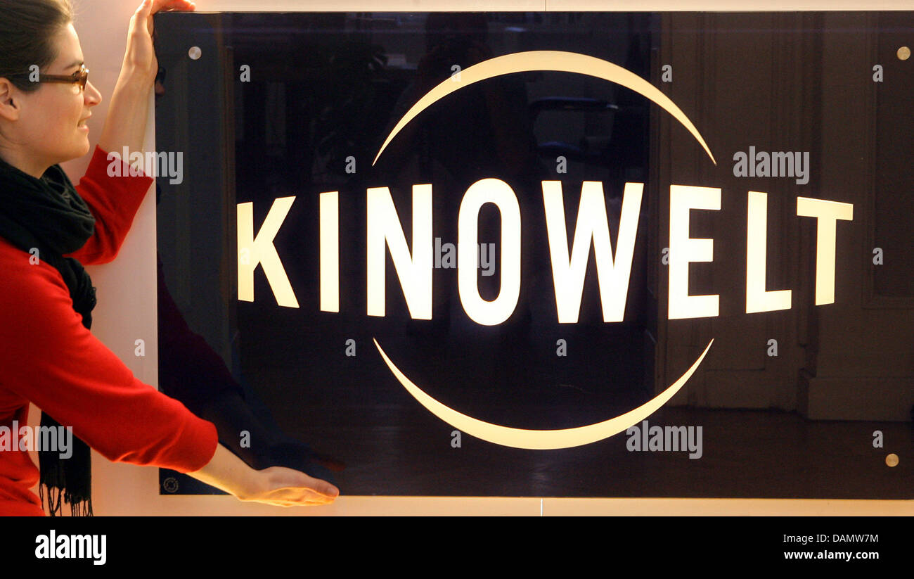 (dpa FIle) - An archive picture, dated 17 January 2008, shows a member of staff standing next to a large logo of film distributor Kinowelt in Leipzig, Germany. The film distributor and co-productin company will move offices from Leipzig to Berlin including around 100 staff. In addition, the company will also take on a new name in reference to its French parent company StudioCanal.  Stock Photo