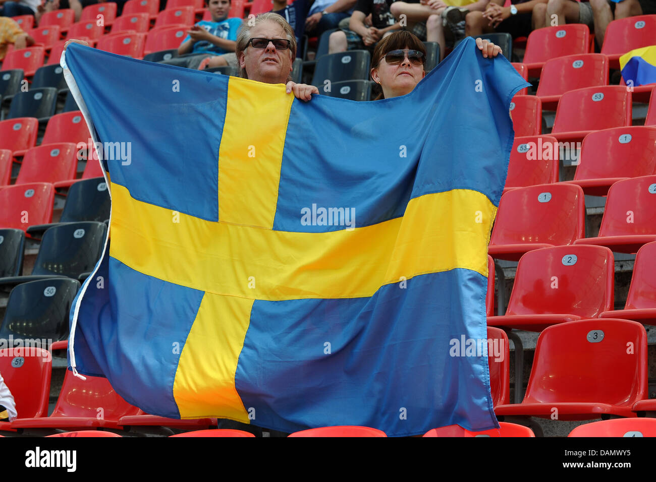 A Sweden fan raises the Swedish national flag during the preliminary round of the FIFA Women's soccer world cup match between Colombia and Sweden in Leverkusen, Germany, 29 June 2011. Photo: Revierfoto Stock Photo